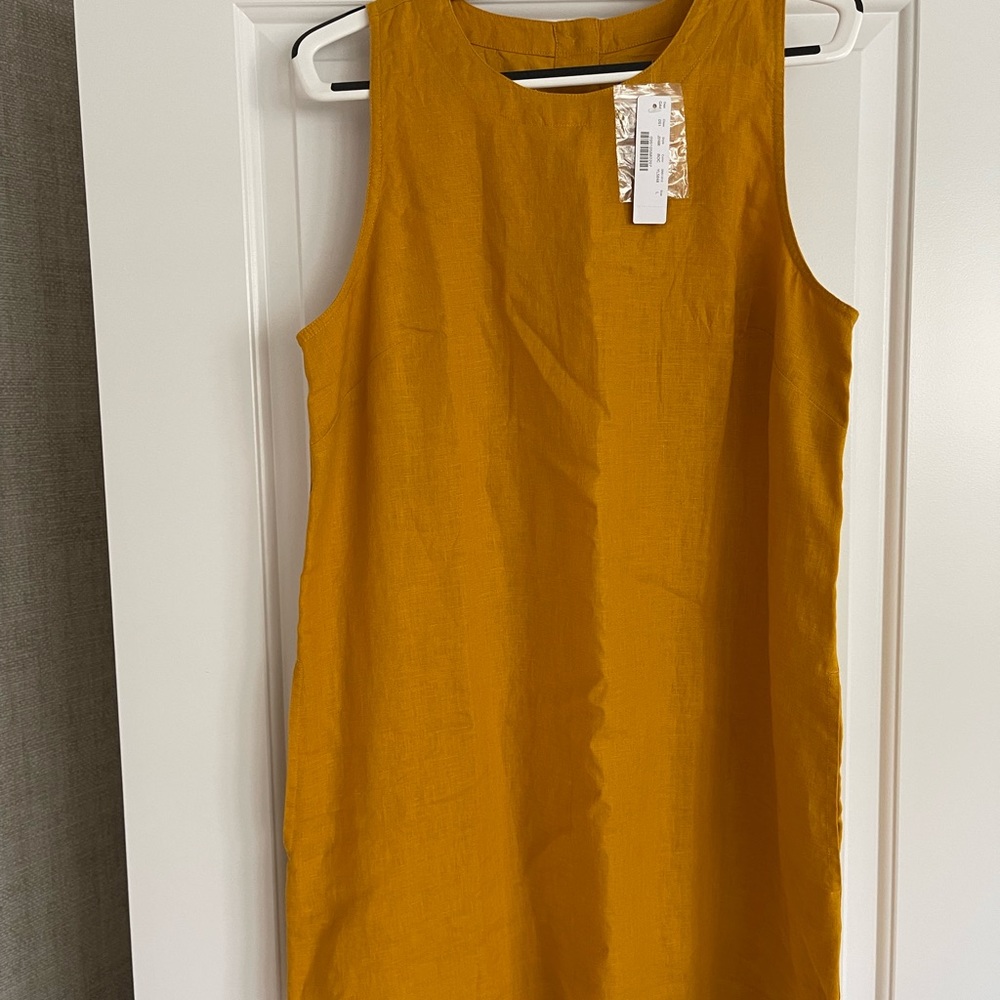 Linen sleeveless dress. Pockets o. The sides, button up back at the top.